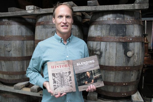 Dr. Don Livermore holding his two books on Canadian Whiskey