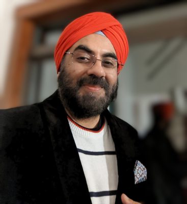 A sikh man wearing a red turban
